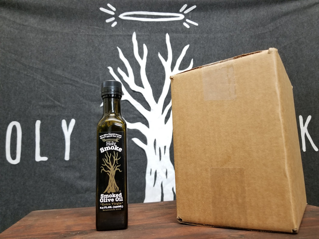 A bottle of smoked olive oil next to a cardboard box
