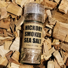 Load image into Gallery viewer, Hickory Smoked Sea Salt in a jar lying on hickory chips
